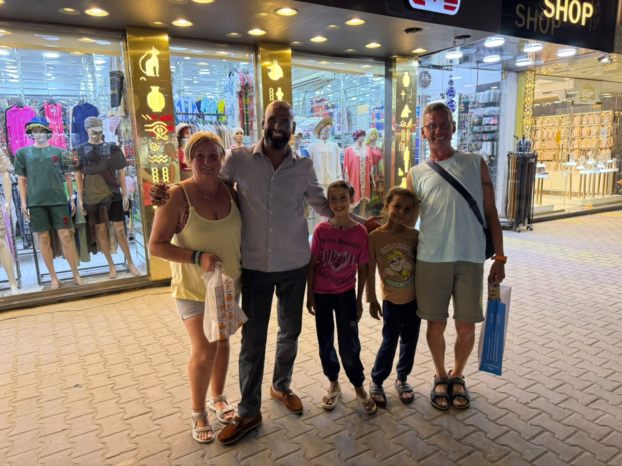 Family guests with their guide during a local shopping tour in Egypt