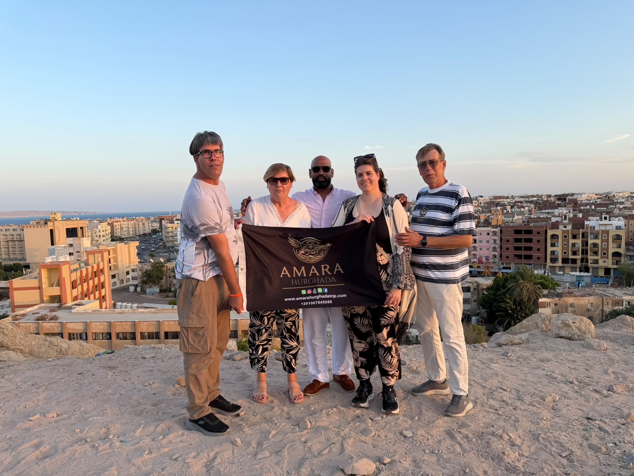 Guests posing with a panoramic Hurghada city view